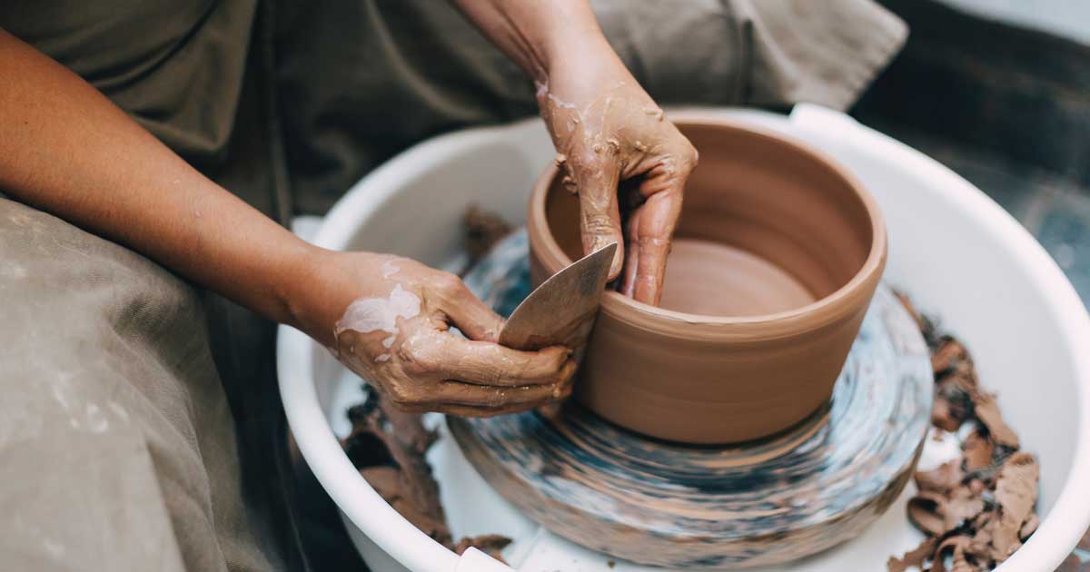 creating pottery on spinning wheel